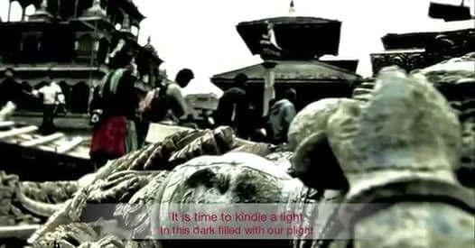 Video still of people clearing rubble beside a damaged temple, overlaid with the subtitle It is time to kindle a light in this dark filled with our plight